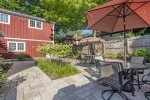 Shared patio area with outdoor dining, BBQ grill, and hot tub